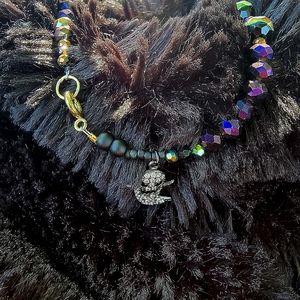 Womens Oil spill glass bead bracelet with a black stainless steel ghoul pendant